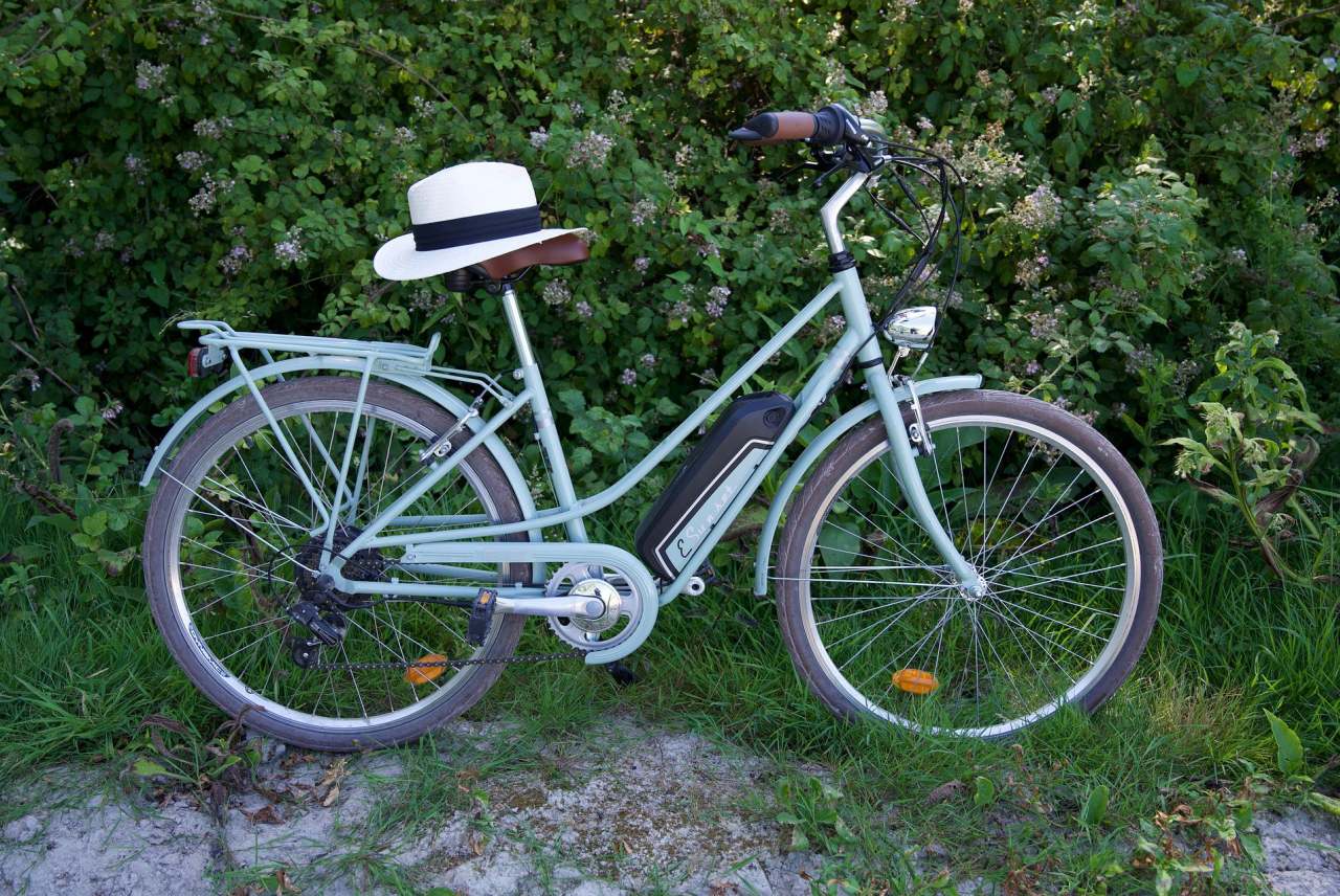 An e-bike outside with a hat on the saddle