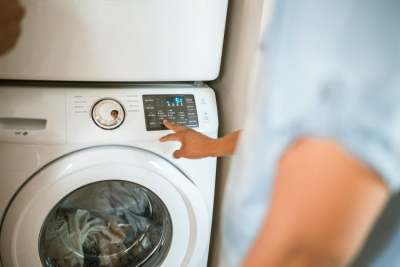 Person chosing settings on a washing machine