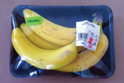 Bananas wrapped in plastic on a tray