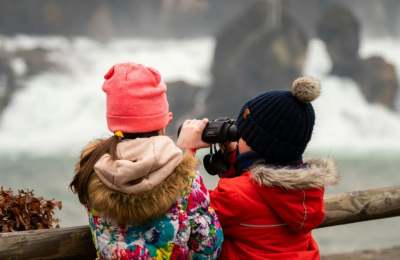 Two children using binoculars