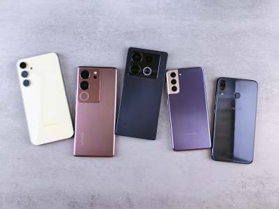 Backs of five smartphones on surface