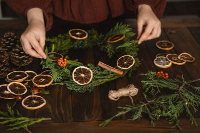 Person making Christmas wreath