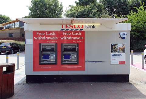 Photo of free cash withdrawal machines under the logo Tesco Bank