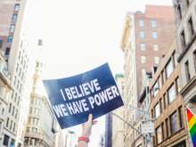 protest banner 'I believe we have power'